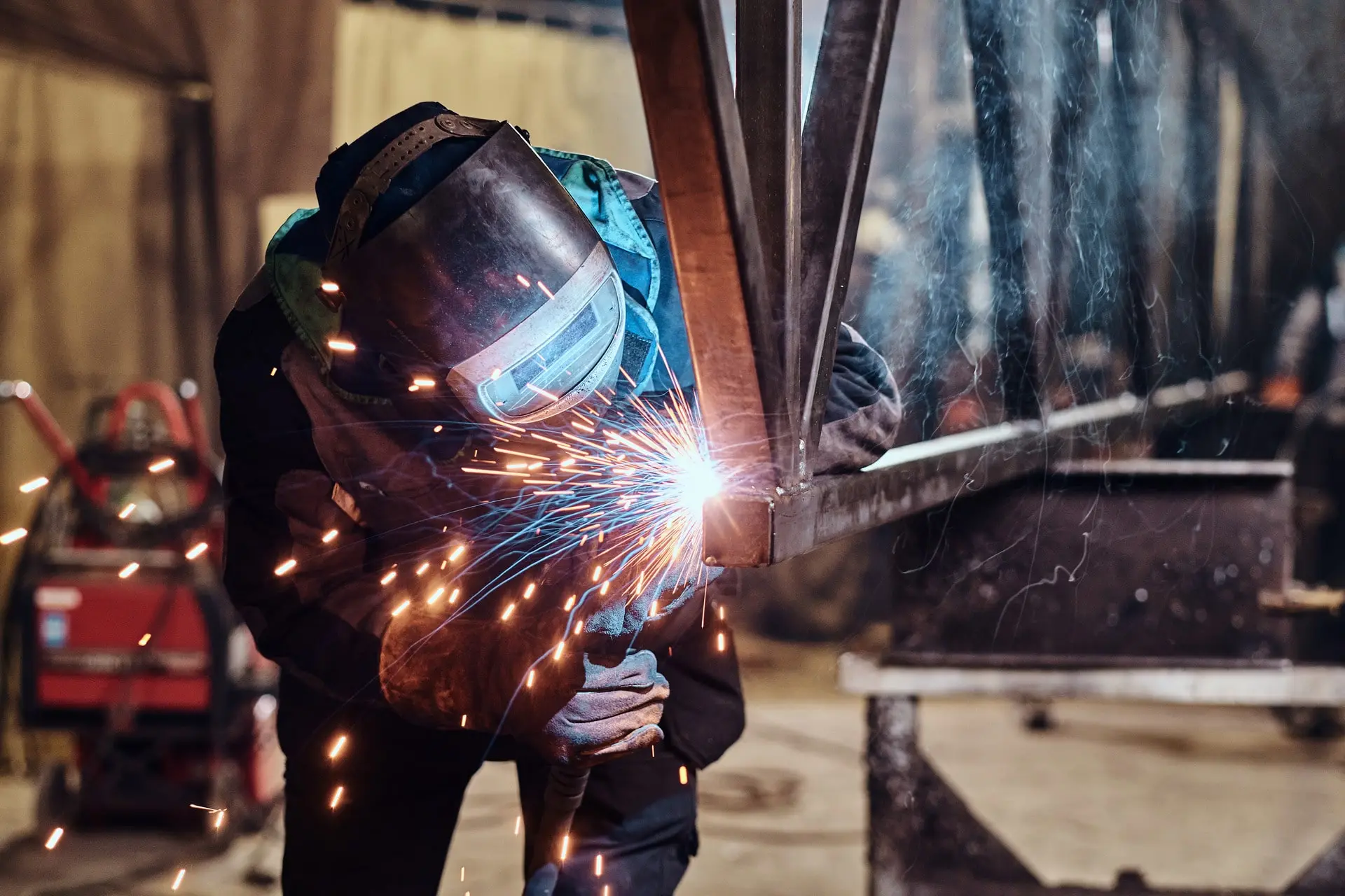 person welding with sparks